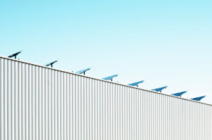 image of sleek building with solar panels 