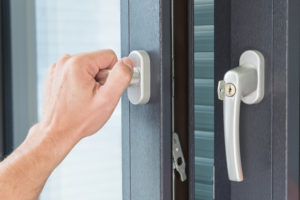 person using lock on home's door