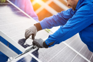 solar panel installer working on panel