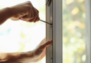 replacement window installer working on sash of window