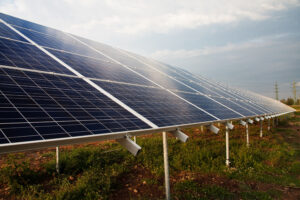 image of sun shining on solar panels